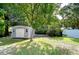 Gray storage shed nestled in a shady backyard at 4008 Greenmark Ln, Valrico, FL 33596