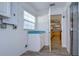 Laundry room with white cabinets and a view of the kitchen at 4008 Greenmark Ln, Valrico, FL 33596