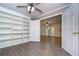 Home office with built-in shelving and hardwood floors at 4008 Greenmark Ln, Valrico, FL 33596