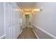 Bright hallway with light wood flooring and built-in closets at 4008 Greenmark Ln, Valrico, FL 33596