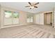 Spacious bedroom with carpeted floor, ceiling fan, and window coverings at 4612 Landscape Dr, Tampa, FL 33624