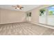 Spacious bedroom with carpeted floor, ceiling fan, and large windows at 4612 Landscape Dr, Tampa, FL 33624