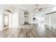 Bright living room with wood-look floors, vaulted ceiling, and fireplace at 12270 Padron Blvd, Spring Hill, FL 34609