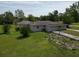 A slightly different aerial perspective, showcasing the home and lawn at 10223 Us Highway 301, Dade City, FL 33525