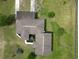 Aerial view of home's roof, landscaping, and placement on large grassy lot at 10223 Us Highway 301, Dade City, FL 33525