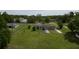 Aerial view of the home, outbuildings, fencing, and mature trees at 10223 Us Highway 301, Dade City, FL 33525