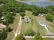 Distant aerial view of the property, showing home, lawn, and nearby lake at 10223 Us Highway 301, Dade City, FL 33525