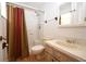 Traditional bathroom with a shower-tub combo, vintage vanity, and neutral-toned tile at 10223 Us Highway 301, Dade City, FL 33525