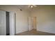 Cozy bedroom with soft carpeting, ceiling fan, and a convenient closet space at 10223 Us Highway 301, Dade City, FL 33525