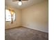 Neutral bedroom featuring carpeted floors, one window with curtain, and cream-colored walls at 10223 Us Highway 301, Dade City, FL 33525