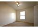 Neutral bedroom featuring plush carpeting, a ceiling fan, and a bright window at 10223 Us Highway 301, Dade City, FL 33525