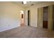 Neutral carpeted bedroom featuring a ceiling fan and closet with paneled doors at 10223 Us Highway 301, Dade City, FL 33525