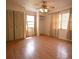 Bright, empty bedroom features wood-look flooring, cream colored walls, and a large closet at 10223 Us Highway 301, Dade City, FL 33525