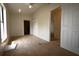 Bright bedroom with neutral carpet, ceiling fan, and white closet and interior doors at 10223 Us Highway 301, Dade City, FL 33525