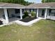 View of the gray home's front porch with fresh black landscaping beds on a grassy lawn at 10223 Us Highway 301, Dade City, FL 33525