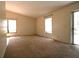 A spacious living room featuring neutral carpet, large windows, and ample natural light at 10223 Us Highway 301, Dade City, FL 33525