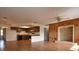 Inviting living room with views into the kitchen with wood-look flooring and wood paneled accent wall at 10223 Us Highway 301, Dade City, FL 33525