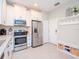 Bright kitchen featuring stainless steel appliances and white cabinets at 9107 Carolina Wren Dr, Tampa, FL 33626