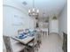 Bright dining room features a farmhouse table with a chandelier at 9107 Carolina Wren Dr, Tampa, FL 33626