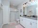 Elegant bathroom with double vanity and a walk-in shower at 9107 Carolina Wren Dr, Tampa, FL 33626