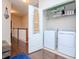 Convenient laundry room with washer, dryer, and shelving at 9107 Carolina Wren Dr, Tampa, FL 33626