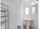 Bright bathroom features a pedestal sink, mirror, and ample shelving unit at 10735 64Th N Ave, Seminole, FL 33772