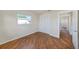 Bedroom features wood flooring, a window, and a closet for optimal storage at 10735 64Th N Ave, Seminole, FL 33772