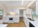 Updated kitchen featuring white cabinets, countertops, and stainless steel sink at 10735 64Th N Ave, Seminole, FL 33772