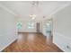 Large living room with hardwood floors, ceiling fans, and access to multiple rooms at 10735 64Th N Ave, Seminole, FL 33772