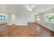 Open living area with beautiful hardwood floors, ample natural light, and brick feature wall at 10735 64Th N Ave, Seminole, FL 33772