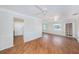 Bright, open-concept living room with hardwood floors, two ceiling fans, and access to the kitchen at 10735 64Th N Ave, Seminole, FL 33772