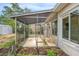 Enclosed screened-in patio extending from the home with a garden area, perfect for outdoor living at 10735 64Th N Ave, Seminole, FL 33772