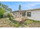 Backyard screened-in patio with a garden area, ideal for outdoor activities at 10735 64Th N Ave, Seminole, FL 33772