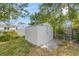 Metal backyard storage shed for tools and equipment, surrounded by lush greenery at 10735 64Th N Ave, Seminole, FL 33772