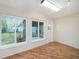 Bright sunroom with wood floors and multiple windows overlooking the backyard at 10735 64Th N Ave, Seminole, FL 33772