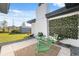 Cozy patio with seating area and artificial greenery wall at 1979 E Skyline Dr, Clearwater, FL 33763