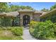 Welcoming front entrance with lush landscaping at 34324 Sunridge, Dade City, FL 33523