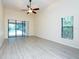 Bright Gathering room featuring sliding doors to pool area and wood-look flooring at 4969 Kilkenney Way, Oldsmar, FL 34677