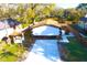 A high-angle shot reveals a well-kept home, a fenced-in yard and a newly-paved driveway at 3010 E 149Th Ave, Lutz, FL 33559