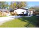 Charming one-story home with a well-manicured lawn and freshly-paved driveway at 3010 E 149Th Ave, Lutz, FL 33559