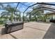 Enclosed lanai featuring a jacuzzi, outdoor barbecue area, and pond views at 331 Star Shell Dr, Apollo Beach, FL 33572