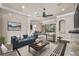 Bright living room with hardwood floors, stone fireplace, and sliding glass doors to the outdoor living area at 331 Star Shell Dr, Apollo Beach, FL 33572
