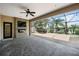 Covered outdoor living area with fireplace and hot tub overlooking the serene lake view at 331 Star Shell Dr, Apollo Beach, FL 33572
