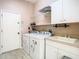 Laundry room with washer, dryer, utility sink, and shelving at 13400 Norman Cir, Hudson, FL 34669