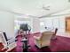 Living room with exercise equipment, hardwood floors, and lots of natural light at 13400 Norman Cir, Hudson, FL 34669