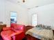 Bedroom with red chair and a view into another room at 13400 Norman Cir, Hudson, FL 34669