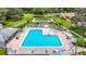 L-shaped community pool with surrounding lounge chairs at 13400 Norman Cir, Hudson, FL 34669