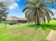 Spacious backyard with large palm tree and fenced area at 13400 Norman Cir, Hudson, FL 34669