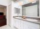 Double vanity bathroom with granite countertops at 13400 Norman Cir, Hudson, FL 34669