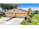 Tan two-story house with a double car garage at 13400 Norman Cir, Hudson, FL 34669